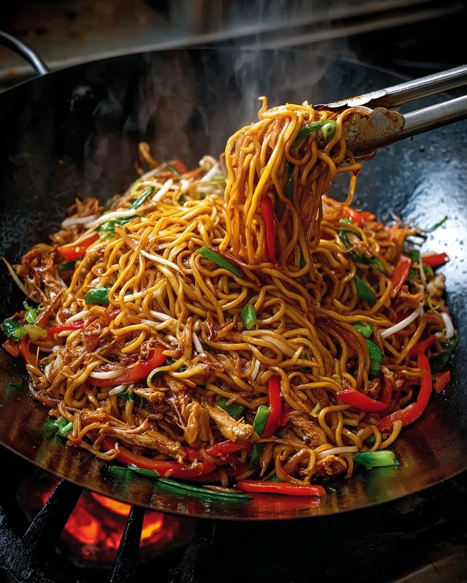 A large black wok filled with stir-fried noodles lifted with metallic chopsticks, showing thick yellow noodles coated in a glossy brown sauce. The noodles mix with thin red bell pepper strips, green leafy vegetables, light brown cooked chicken pieces, and white bean sprouts, all evenly spread in the wok. The colors are bright and fresh, with the red peppers and green veggies standing out against the shiny noodles. The wok sits on a stove with a dark background. photo taken with an iphone --ar 4:5 --v 7