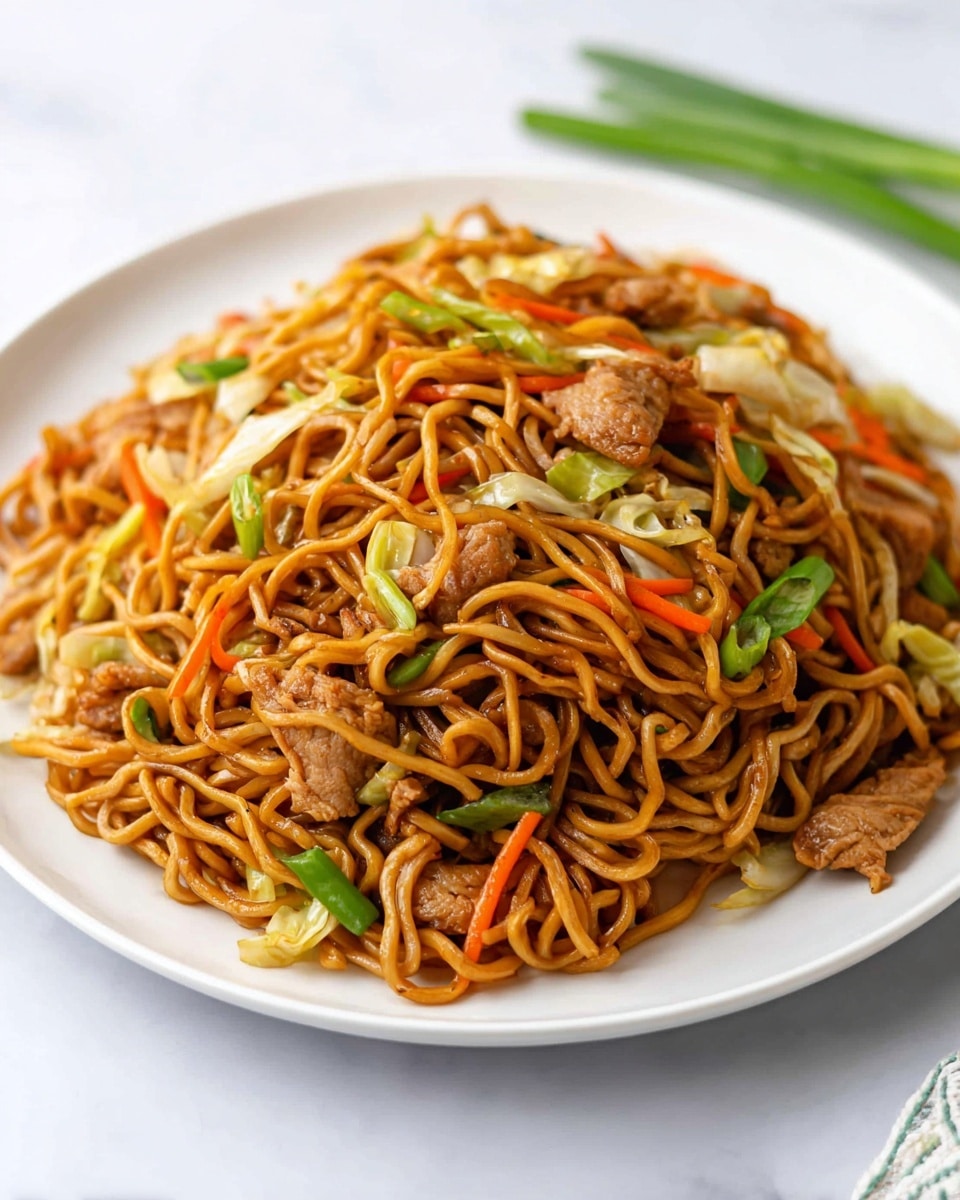 A large white plate holds a generous pile of stir-fried noodles, golden brown and slightly glossy from sauce. Mixed throughout the noodles are pieces of cooked chicken, light brown in color, with strips of bright orange carrot, light green celery slices, white onion strips, and a few green leafy bits scattered on top. The noodles are long and thin, interwoven with the vegetables and chicken, creating a mix of soft and crunchy textures. The plate sits on a white marbled surface, giving a clean and bright background to the dish. photo taken with an iphone --ar 4:5 --v 7