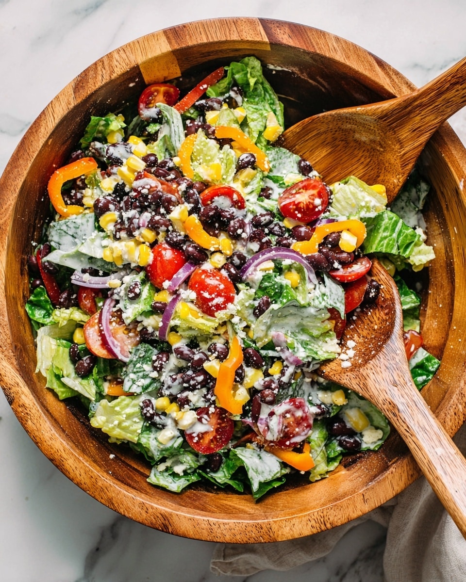 A large wooden bowl holds a colorful salad with many layers, starting with a base of green lettuce leaves. On top are black beans scattered throughout, along with bright yellow corn kernels, thin red and orange bell pepper rings, and slices of purple onion. Red cherry tomatoes, some halved, are mixed in, and small green leaves add freshness. The salad is lightly sprinkled with white cheese crumbles, and a creamy dressing is drizzled over it. Two wooden salad spoons rest inside the bowl, one partly scooping some salad. The bowl sits on a white marbled surface photo taken with an iphone --ar 4:5 --v 7