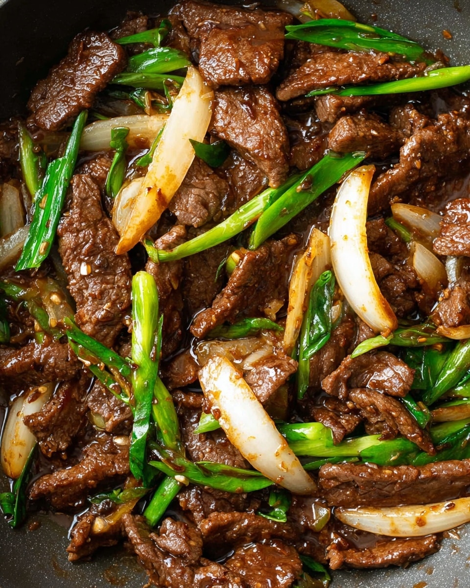 A white plate holds a serving of dark brown, cooked beef slices mixed with light brown caramelized onions and bright green sliced scallions. The beef looks tender with a slightly shiny glaze, and the green scallions sit on top and among the meat, adding a fresh contrast. The dish is placed on a white marbled surface, and a metal fork rests on the side with a woman's hand reaching toward the food. Photo taken with an iphone --ar 4:5 --v 7