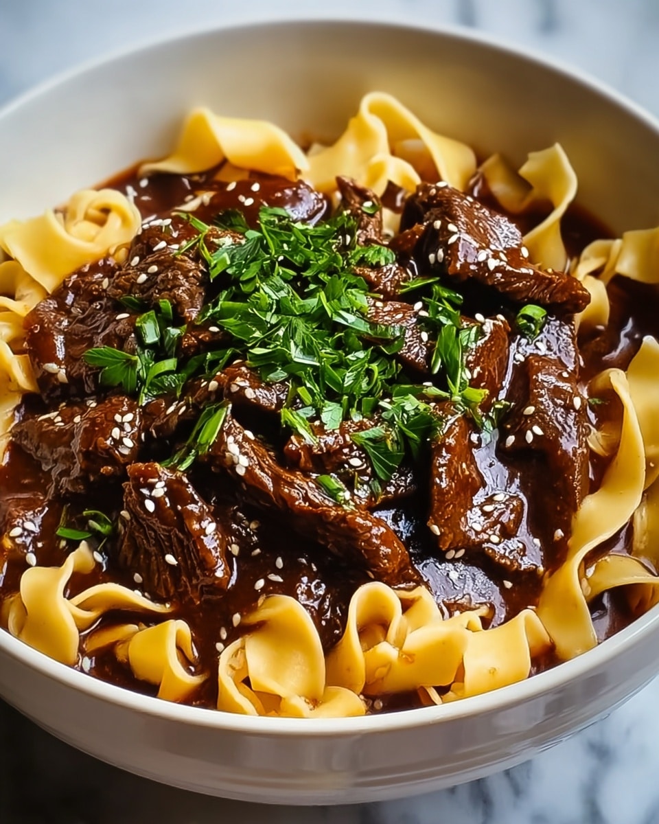 A white bowl filled with two main layers of food: the bottom layer is wide, flat, curly orange pasta, and on top is a thick layer of dark brown beef stew with chunks of beef covered in rich sauce. The stew is sprinkled with small white sesame seeds and fresh green chopped parsley. The bowl sits on a white marbled textured surface with part of a dark blue cloth visible nearby. Photo taken with an iphone --ar 4:5 --v 7