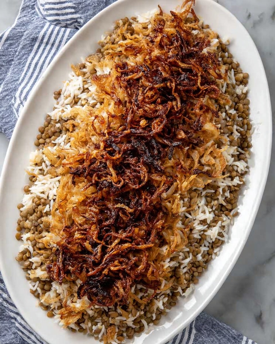 An oval white plate holds a dish with two main layers. The bottom layer is a mix of light brown cooked rice with small greenish-brown lentils, showing a soft texture and loose grains spread evenly across the plate. On top, there is a thick, central strip of thin, crispy caramelized onions that are dark brown with some blackened edges, giving a crunchy look contrasting with the softer rice and lentils underneath. The plate sits on a white marbled surface with a folded white cloth that has blue stripes partially visible at the bottom left corner. photo taken with an iphone --ar 4:5 --v 7