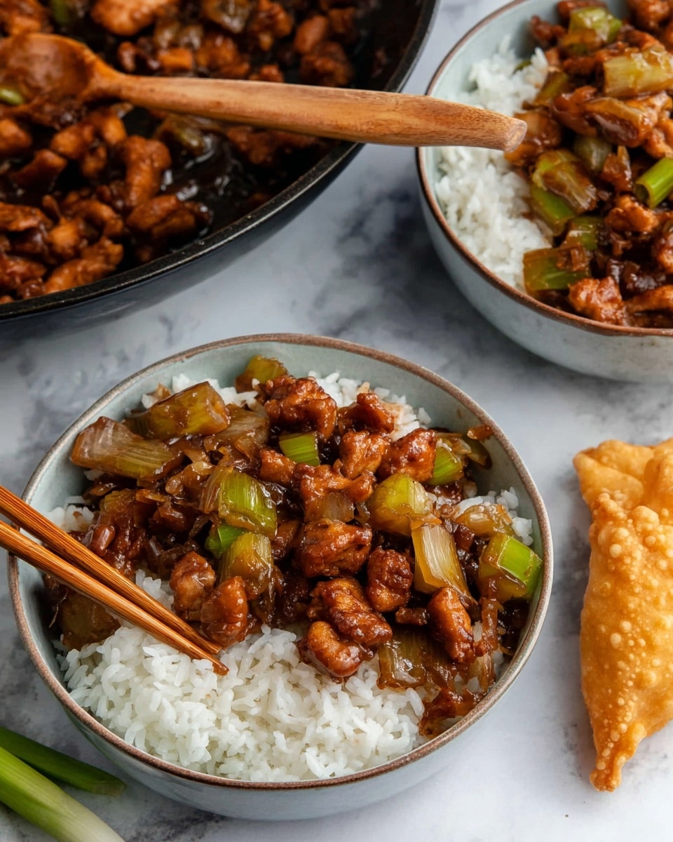 A close-up view of a cooked stir-fry dish shows three main layers: dark brown pieces of chicken coated in a shiny glaze, light green celery chunks with a crisp texture, and translucent white onion pieces all mixed together. The glossy sauce covers everything, giving it a rich look. A dark wooden spoon lifts a portion of the stir-fry, highlighting the detail and texture of the meat and vegetables against the mix in the pan beneath. The background shows just more of the dish, placed on a white marbled texture. photo taken with an iphone --ar 4:5 --v 7