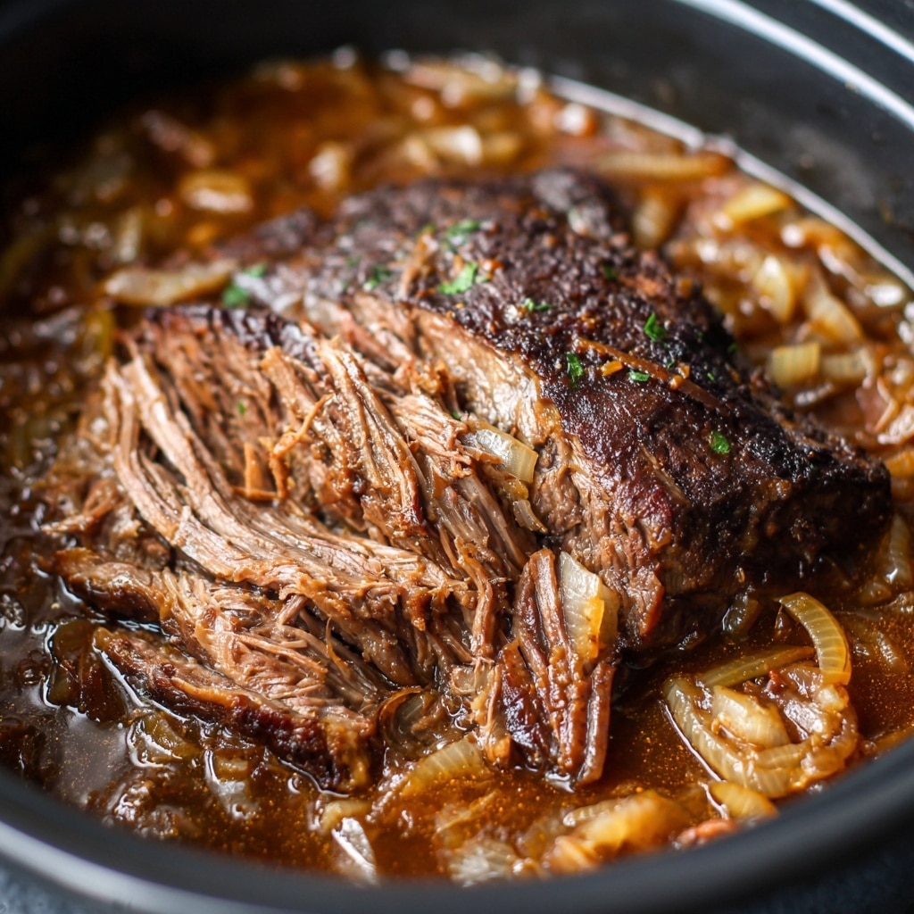 A cooked beef roast sits in a slow cooker, surrounded and topped with a thick layer of soft, golden-brown cooked onions in a rich, shiny brown gravy. The beef is dark brown and slightly shredded, showing tender inner layers with a fibrous texture. The onions are translucent with a slight glaze from the sauce, and the gravy fills the bottom of the slow cooker, pooling around the beef. The slow cooker is black and the scene is set on a white marbled texture. photo taken with an iphone --ar 4:5 --v 7